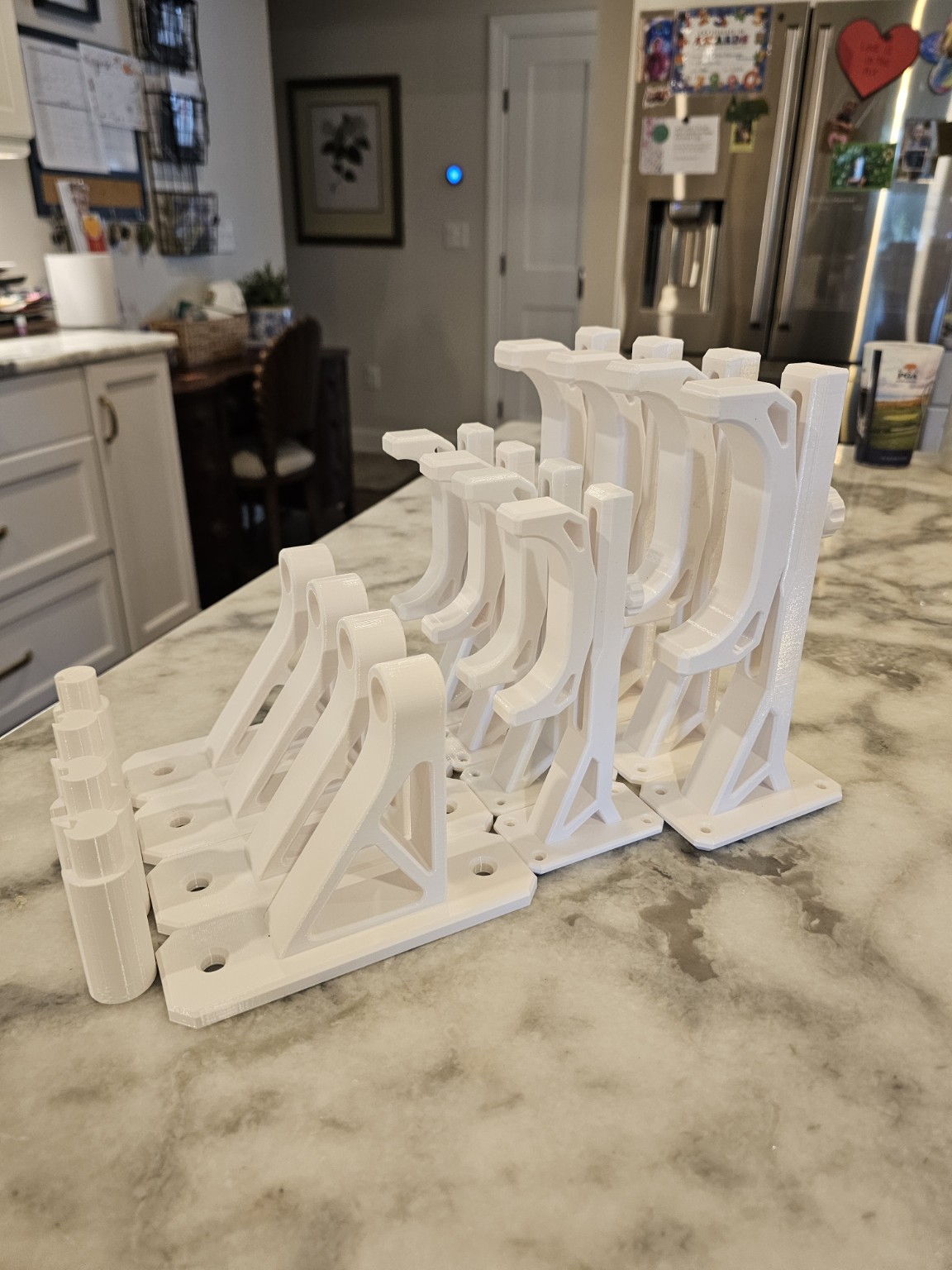 Multiple white ITERA model rocket wall mounts in different sizes